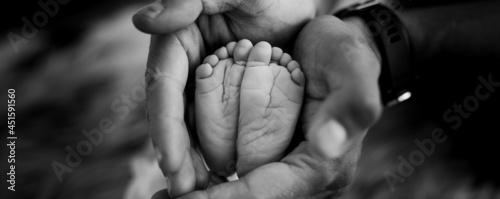 Small 1 week old newborn baby feet photo