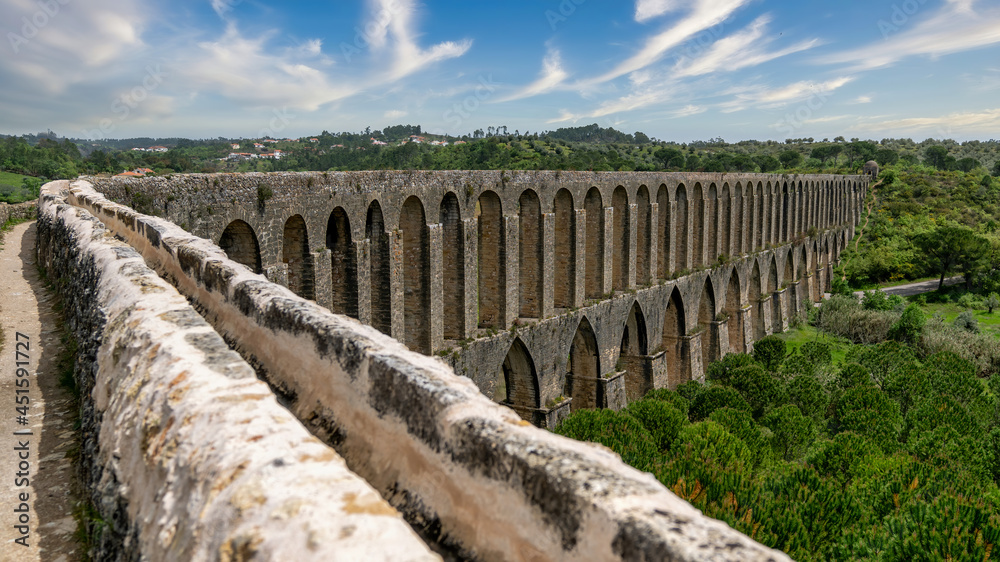 Tomar, Portugal - April 2018: Pegoes aqueduct by the Castle and Convent of the Order of Christ