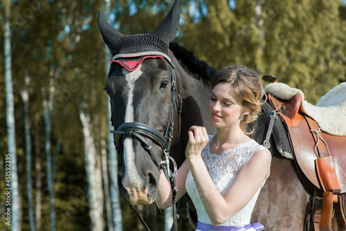 Beautiful portrait of woman bride with horse