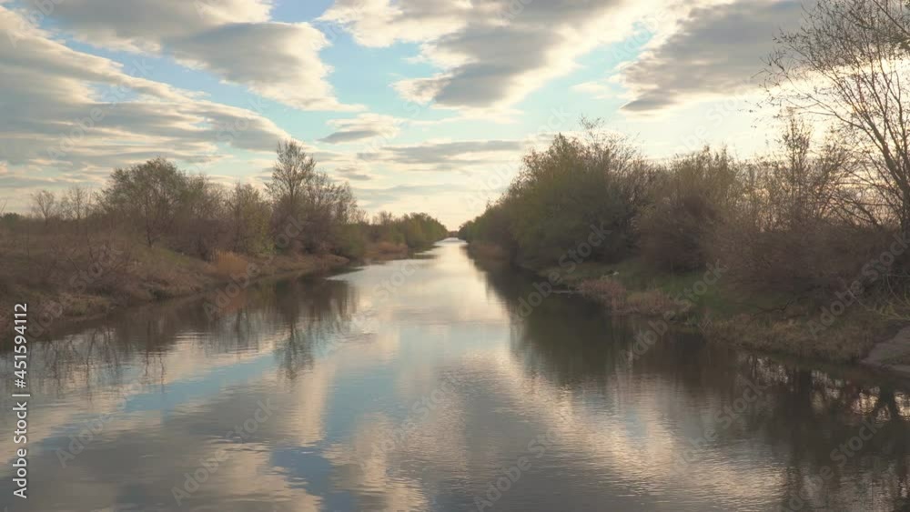 View of a quiet little river with calm water View of a quiet little river with calm water