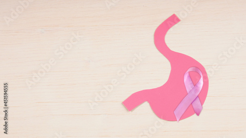 stomach silhouette with stomach and bowel cancer awareness ribbon