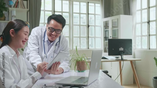 Wallpaper Mural Hospital Medical Doctor'S Office: Two Asian Professional Physicians Talking, Consulting And Working On Tablet. Specialists Discuss Patient Online Treatment, Writing Digital Medicine Prescriptions
 Torontodigital.ca
