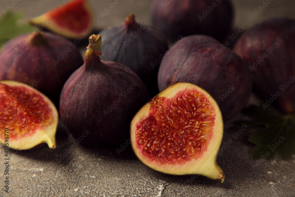 Fresh ripe figs on grey background. Tropical fruit Fresh ripe figs on grey background. Tropical fruit