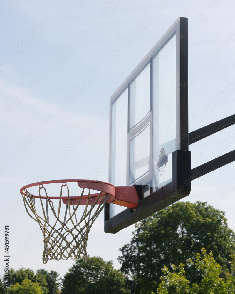 Basketball hoop and net outside on summer day