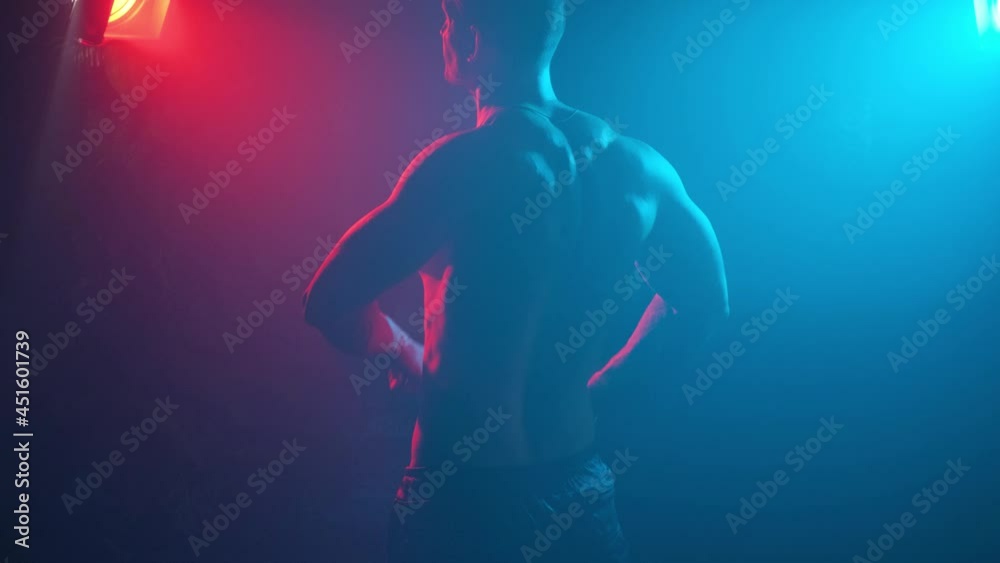 Young muscular guy in the studio with new lights and smoke. Young muscular guy in the studio with new lights and smoke.