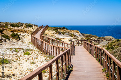Fototapeta Naklejka Na Ścianę i Meble -  Wooden walkways by the Atlantic Ocean in Zambujeira Do Mar, Alentejo, Portugal