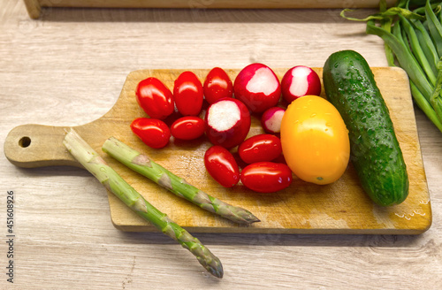 fresh green, red, yellow vegetables on wooden desk