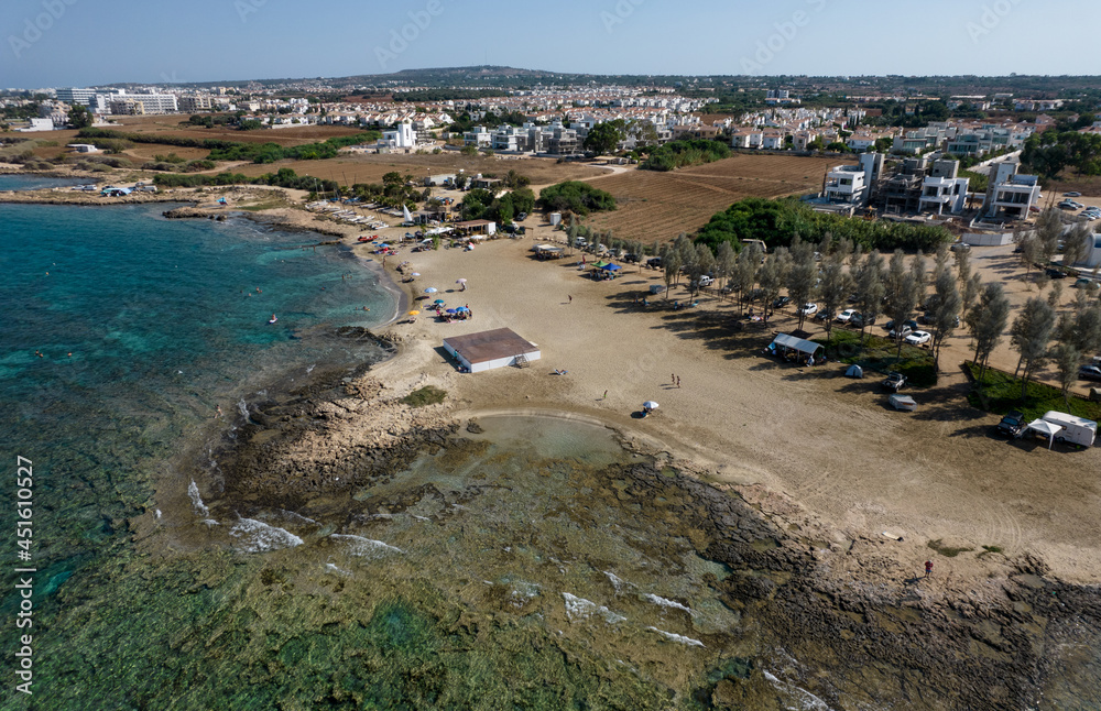 Aerial drone view of Agia Triada coastline and people swimming in the sea. Protaras Paralimni Cyprus