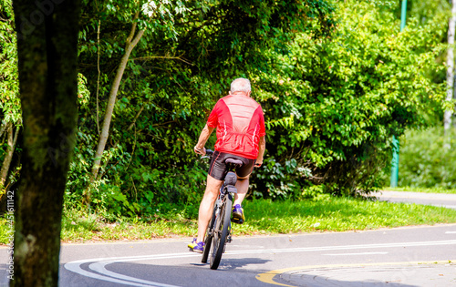 Wallpaper Mural Cyclist ride on the bike path in the city Park
 Torontodigital.ca