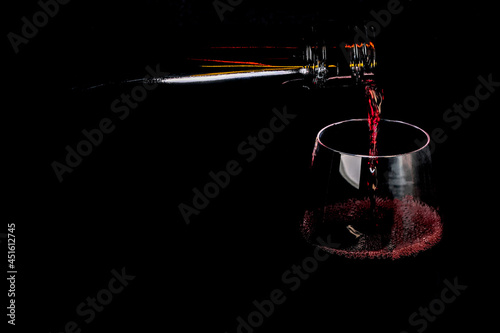 Red fortified wine is poured into a glass
