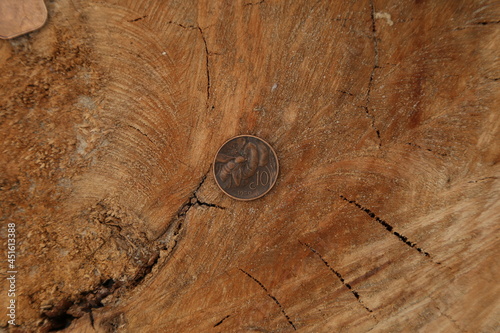 Canvas Print Old Italian coin on wooden surface