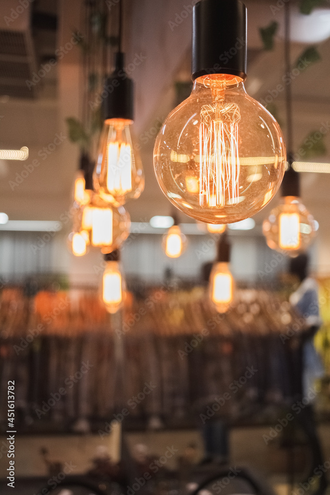 Focusing on hot lamps hanging in a designer clothing store Focusing on hot lamps hanging in a designer clothing store
