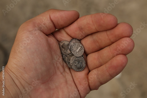 Ancient Roman silver coins in hand