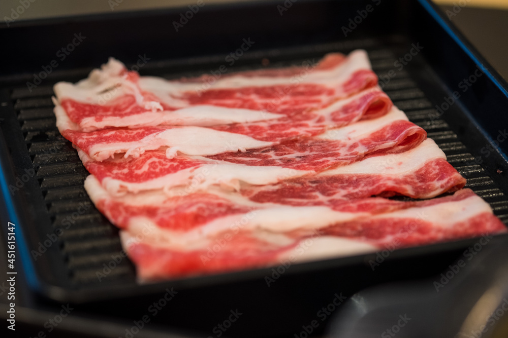 Thin sliced beef in black tray prepare for Sukiyaki