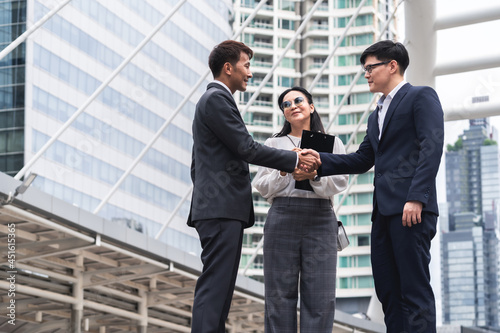 Businessmen and business woman shaking hands during a meeting with reach an agreement for business,Handshake Gesturing People Connection Deal Concept