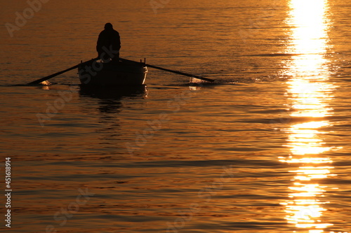 Fisherman paddling to the shore