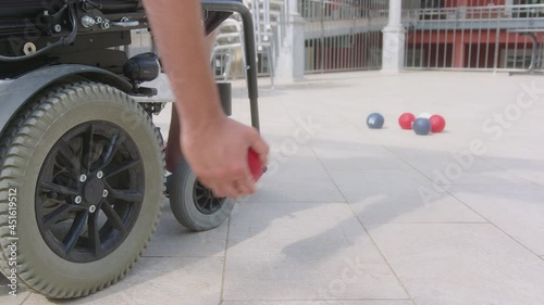 Disabled Boccia player playing on a wheelchair photo