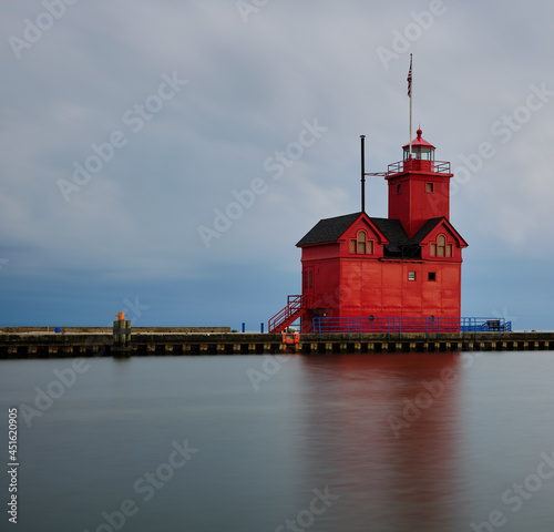 Big Red Lighthouse at the entrance to Macatawa lake and bay on Lake Michigan photo