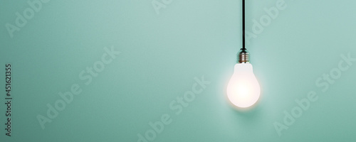 One hanging light bulb glowing on blue background for creative thinking idea and innovation concept by 3d render. photo