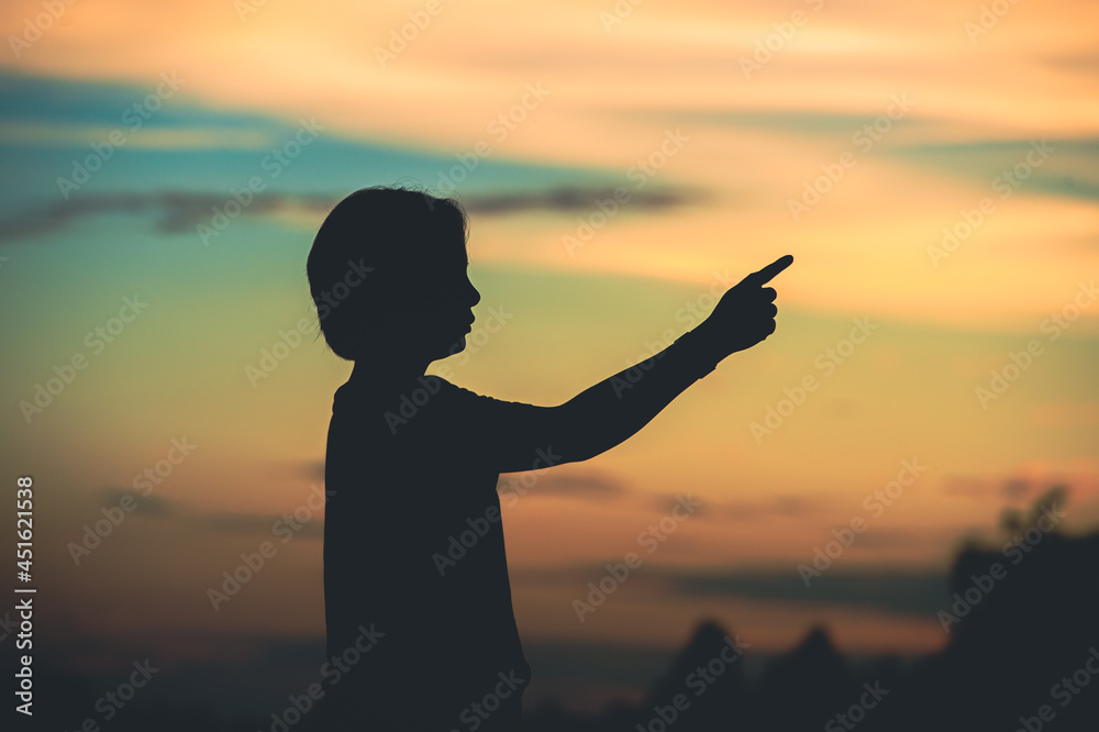 young woman pointing her hand aiming destination success at sunset.