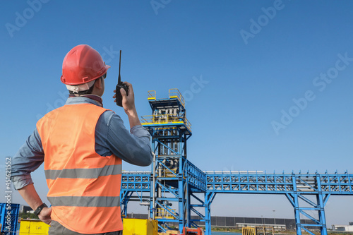 Fotografie Steve Vader, or the foreman wearing reflective jacket hand holding walkie talkie