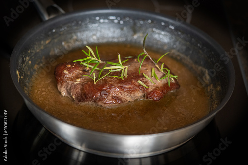 a part of the topside from a roe deer meat in the pan for a roast