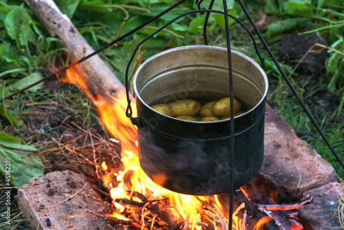 Dixie with potatoes stands on the fire, close-up photo