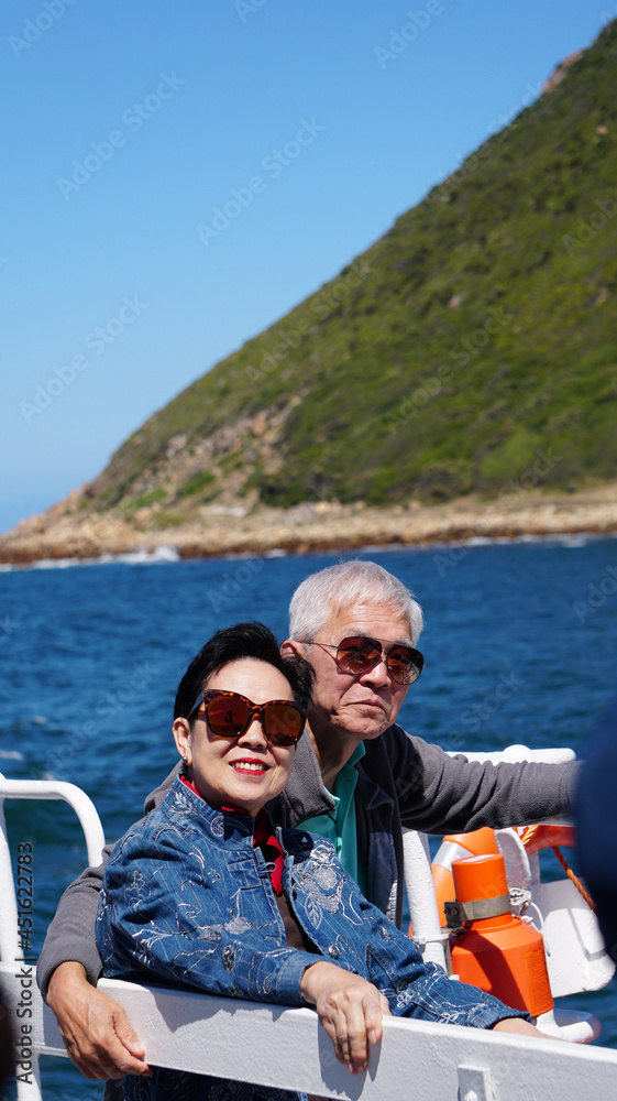 Asian senior elderly couple on tourist ferry boat to seals island trip attracion Fun wildlife watching aticity in South Africa trip
