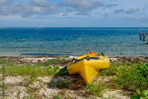 Bright Yellow Sea Kayak sits on the shore of the crystal clear waters of the Dry Tortugas in the Gulf of Mexico