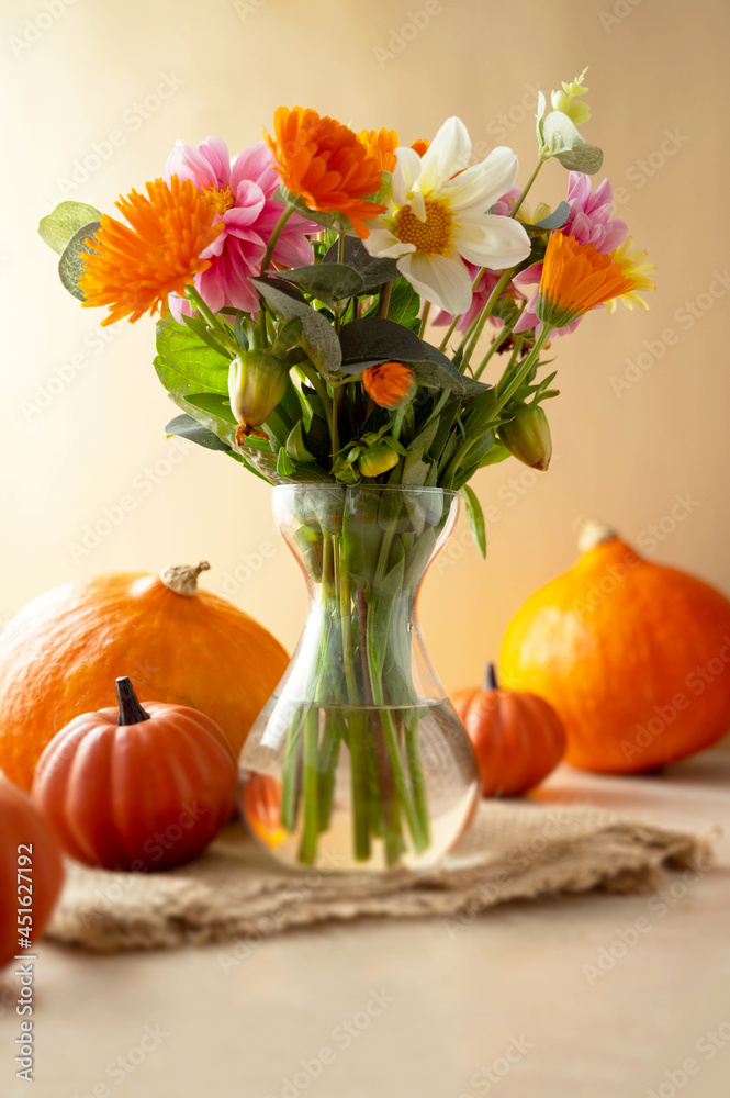 Autumn beautiful composition with flower bouquet in vase and pumpkins,fall warm backdrop Autumn beautiful composition with flower bouquet in vase and pumpkins,fall warm backdrop
