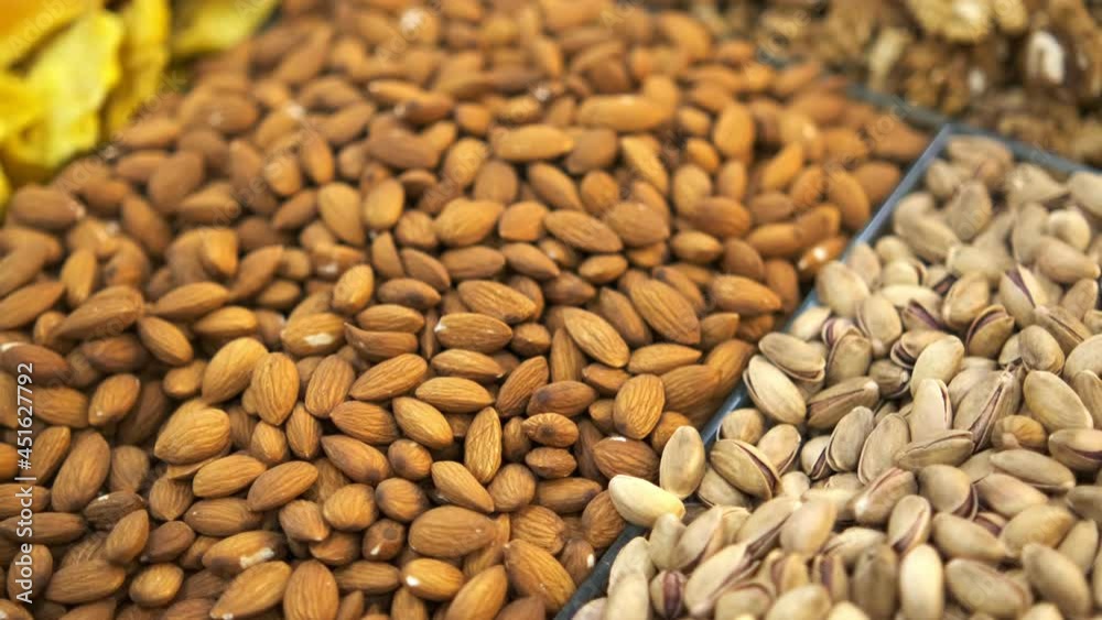Large Counter of Dried Fruits and Nuts at a Farmers Market . Nuts, dry fruits on display at the market on the showcase. Stall with Various dried fruits Large Counter of Dried Fruits and Nuts at a Farmers Market . Nuts, dry fruits on display at the market on the showcase. Stall with Various dried fruits
