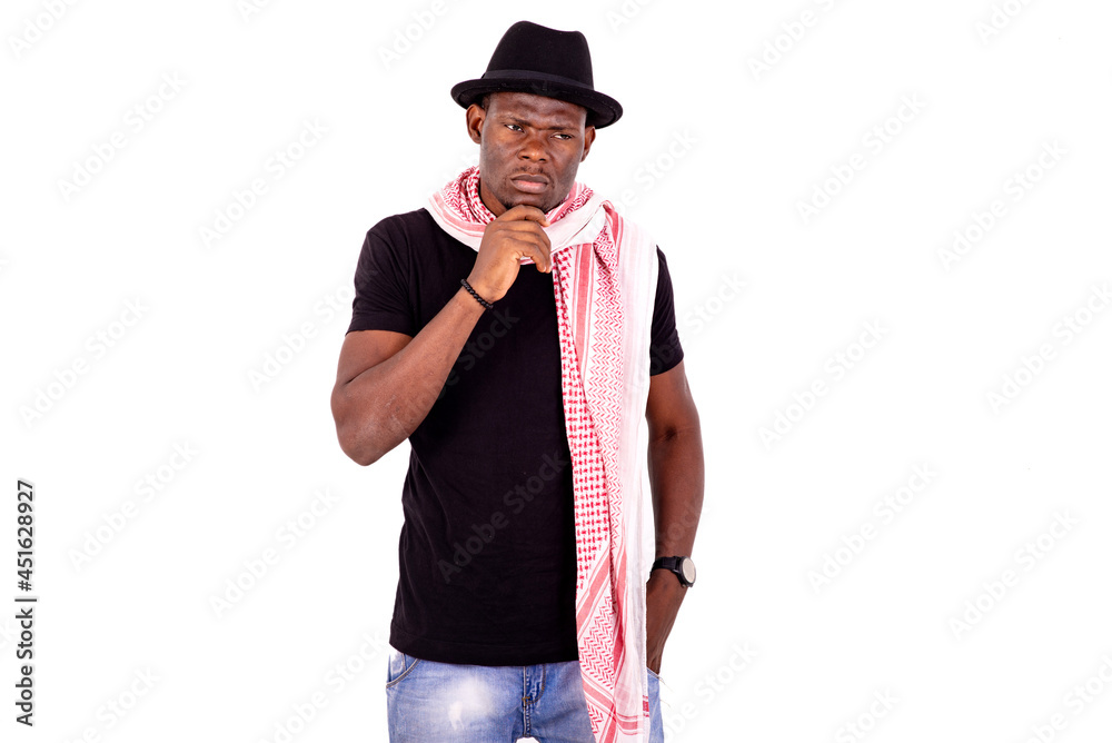 handsome pensive young man holding hand under chin. handsome pensive young man holding hand under chin.