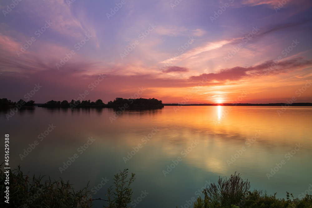 Lake Musov - South Moravia - Czech Republic. Calm water at sunset. Beautiful clouds in the sky.