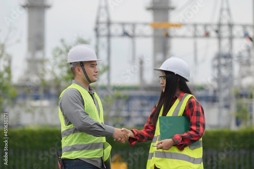 Two engineer working at power plant Work together happily Help each other analyze the problem Consult about development guidelines