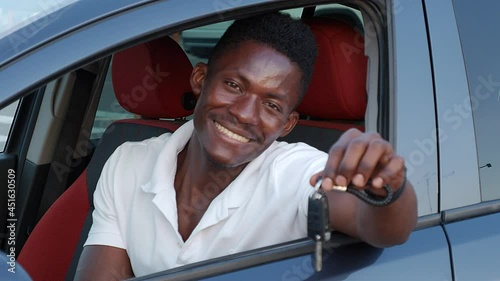 beautiful African American man in a car with keys