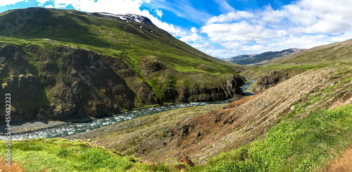 Summer Iceland panorama on winding river among fields and hills of green grass. © Savour_of_day