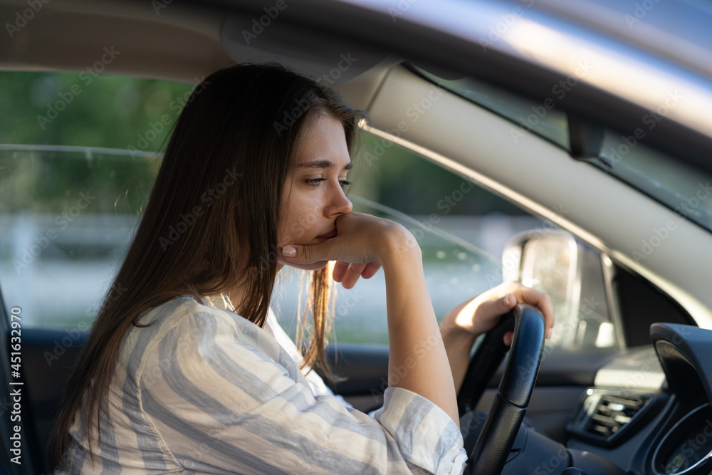 Drunk girl driving car. Unhappy young female sit on driver seat suffering from headache or handover. Depressed tired woman in vehicle. Sleepy exhausted lady in auto in traffic jam looking frustrated Drunk girl driving car. Unhappy young female sit on driver seat suffering from headache or handover. Depressed tired woman in vehicle. Sleepy exhausted lady in auto in traffic jam looking frustrated