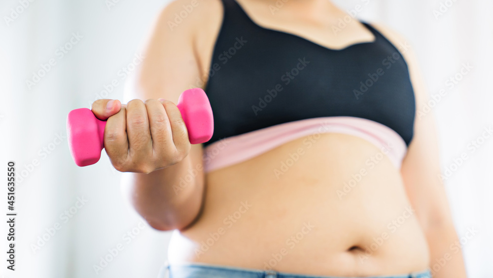Overweight obese woman exercises on mat fitness Dieting and healthy lifestyle for burning fat Overweight obese woman exercises on mat fitness Dieting and healthy lifestyle for burning fat