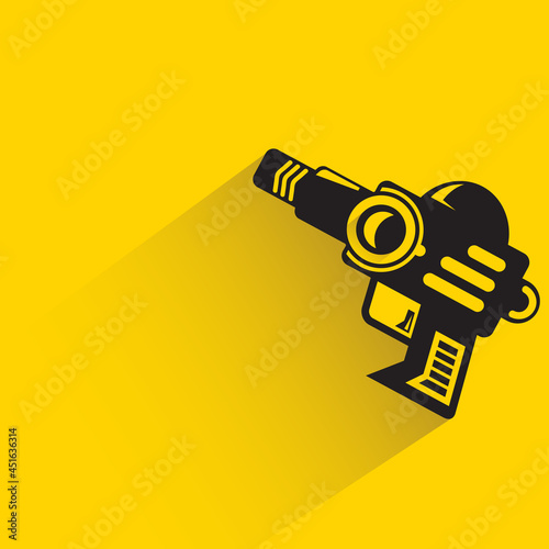 space blaster gun or fantastic raygun icon on yellow background