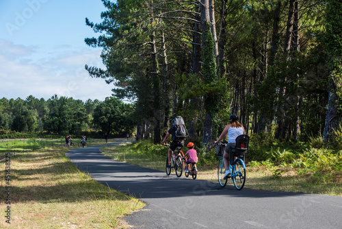 cyclists on the bike path through the forest