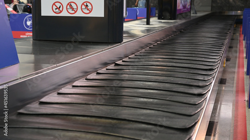 Empty suitcase or luggage with conveyor belt at the airport.  photo