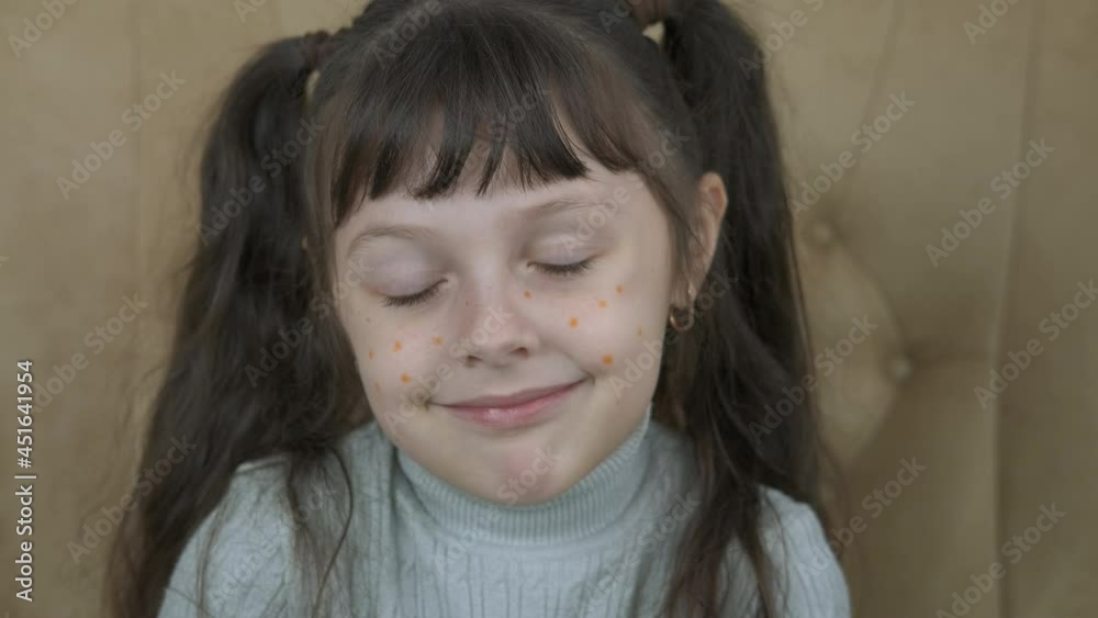Freckles face. A view of a smiling child with frenkles face in the room.