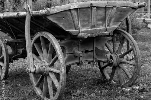 Antiquarian transport. Old wooden two-wheeled cart, vehicle. Black and white photo