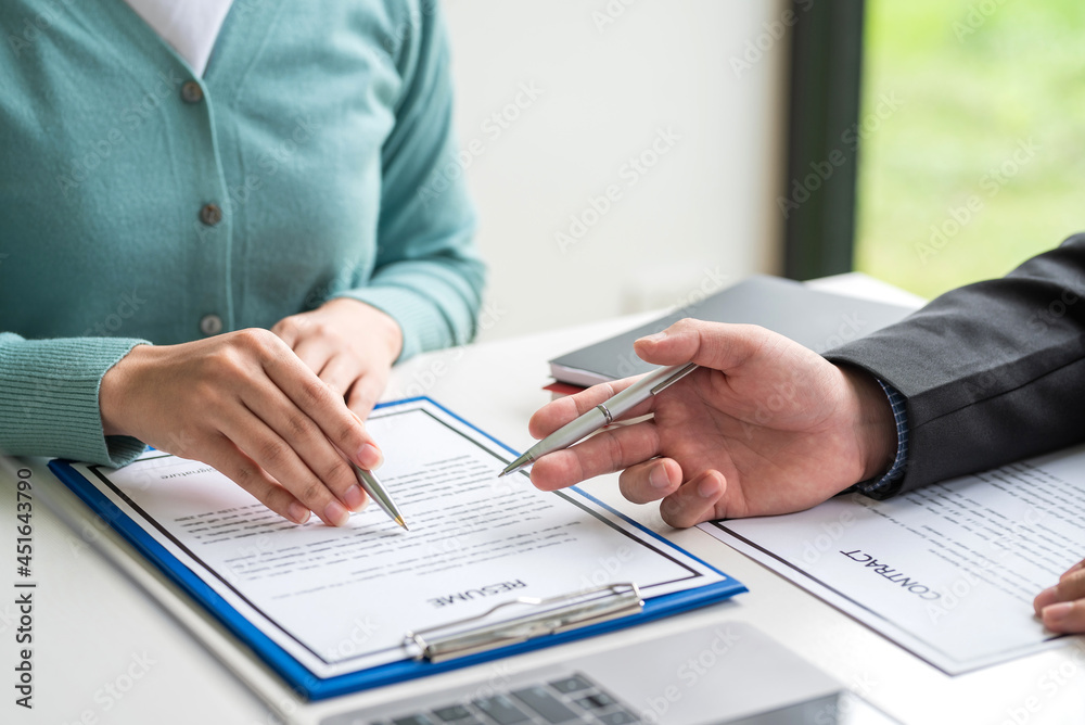 Businessman collaboration agreement resume employment contract documents at the office. Businessman collaboration agreement resume employment contract documents at the office.