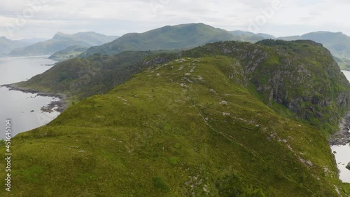 Aerial View Of The Coastal Cliffs At Maaloy Town In Vagsoy Island In Norwegian County Of Vestland.  photo