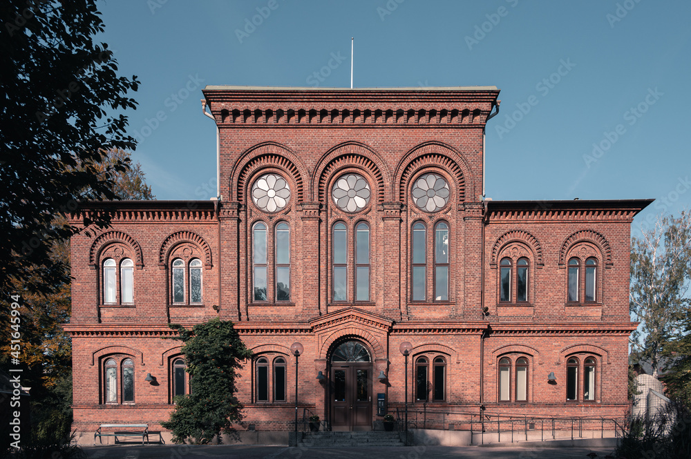 Grand university building with red brick facade and big windows in Lund Sweden