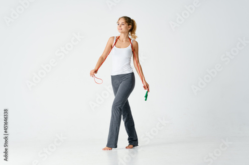 sportive woman skipping rope in hands health workout isolated background