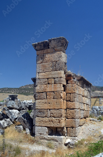 Ruins of ancient column and construction blocks of antique city Hierapolis  in Pamukkale  Turkey