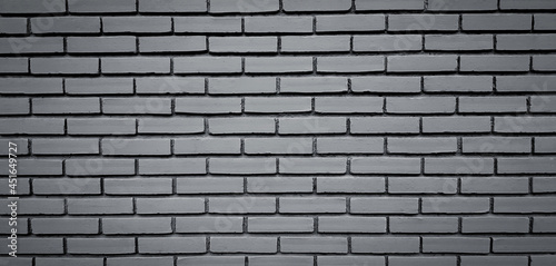 Gray or grey brick wall background. Grunge cement painted wallpaper. Block exterior and Retro, Loft or Vintage built style in black and white tone or monochrome.