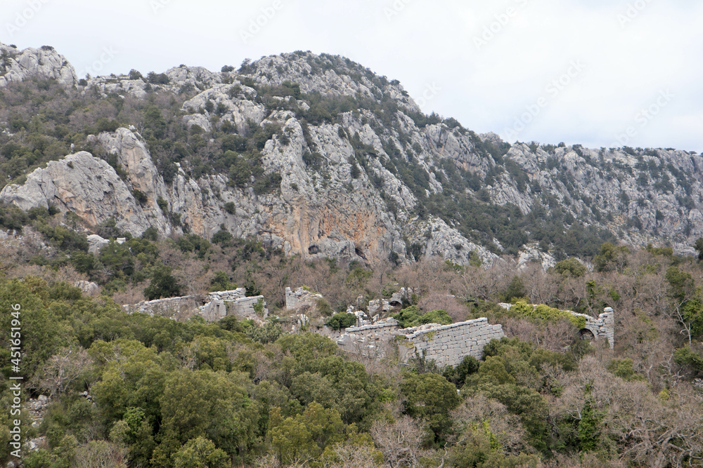 panoramic view from the top of the mountain to the ruins of ancient abandoned city Termessos in Turkey